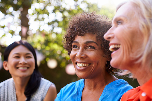 A group of smiling older women with dental implants from Greashaber Dentistry in Ann Arbor, MI